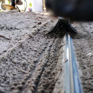 Sliding gate track close-up with Mr. Sweepie® brush kit - for steep driveways where debris washes down, we recommend two sets per gate.